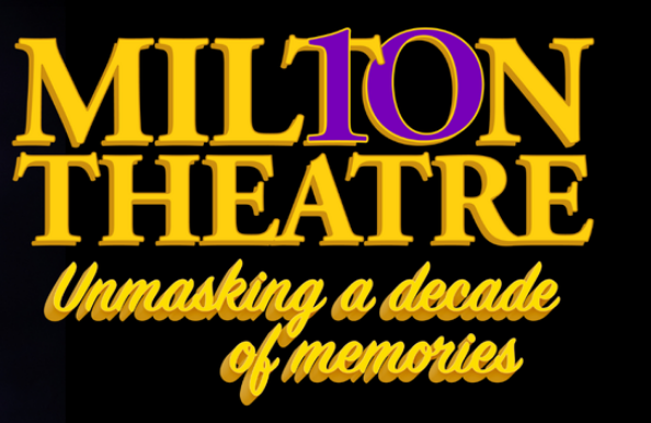 a man in a suit and tie standing in front of a black background