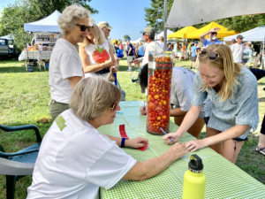 a group of people standing around a table