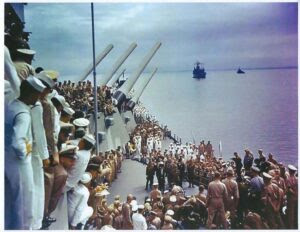 a group of people standing on top of a boat