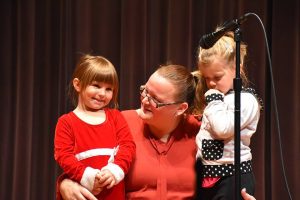 teacher and 2 kids on stage