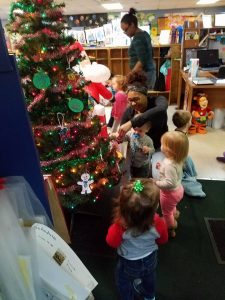 kids around a fake christmas tree