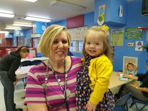teacher holding toddler