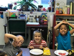 three kid eating snacks