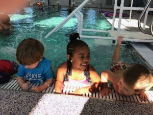 kids smiling in indoor pool