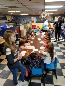 kids in day care center eating snacks