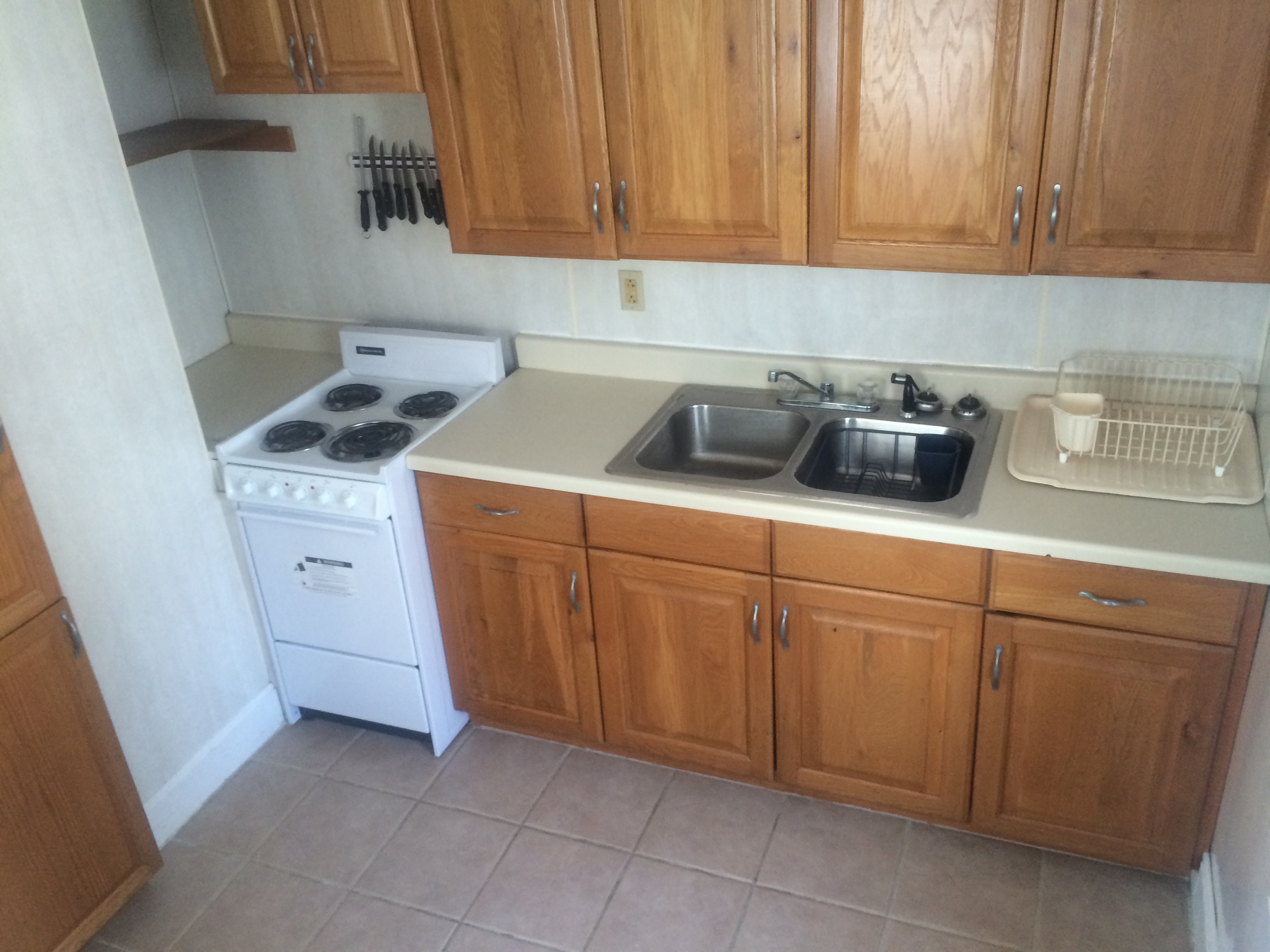 kitchen with stove, sink and cabinets