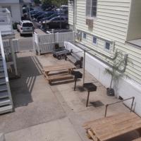 exterior patio with grills and table