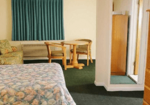 bedroom with queen size bed and sofa