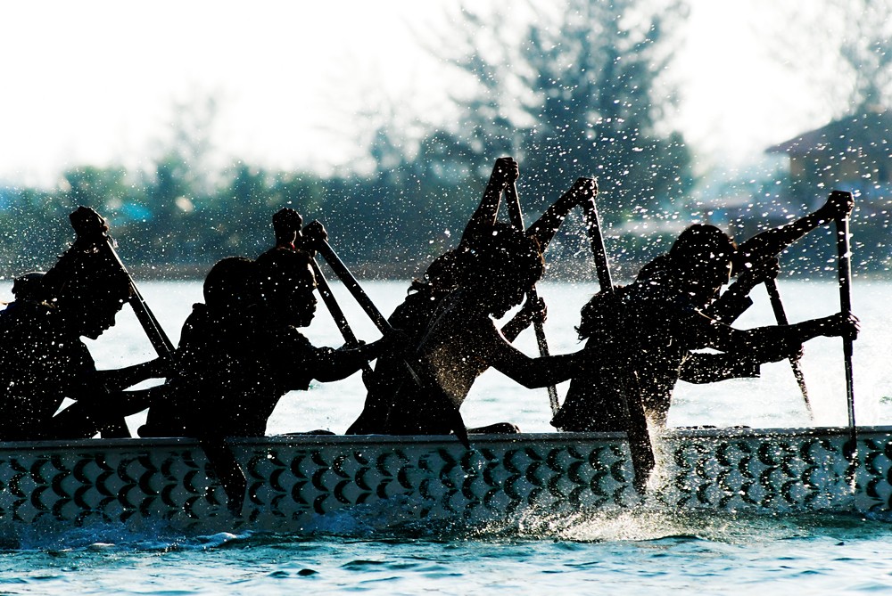 People rowing a canoe on the water