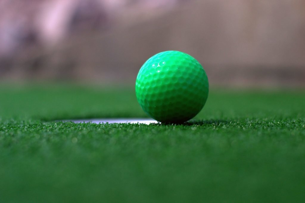 close up of green golf ball on green