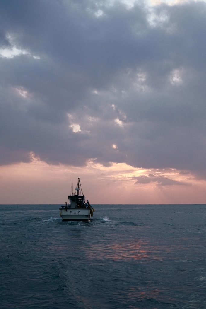 boat in ocean at sunrise