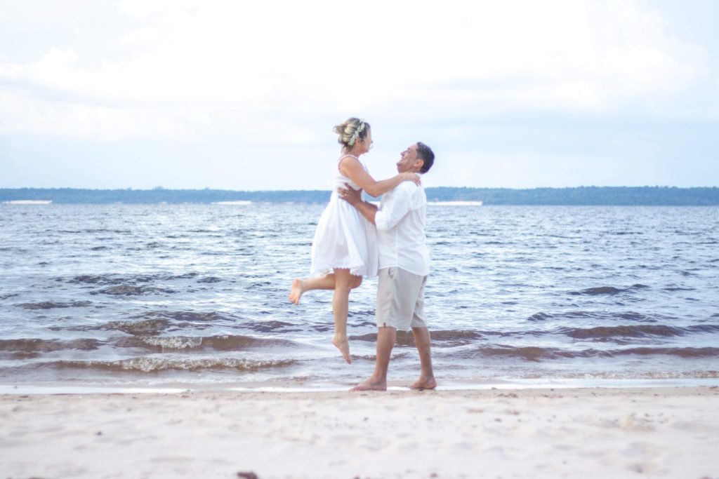 female and male couple on beach for wedding