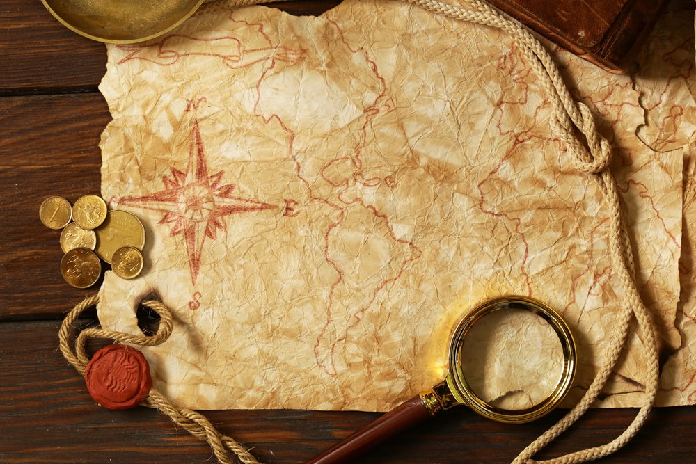 distressed paper/map of word with magnifying glass and rope