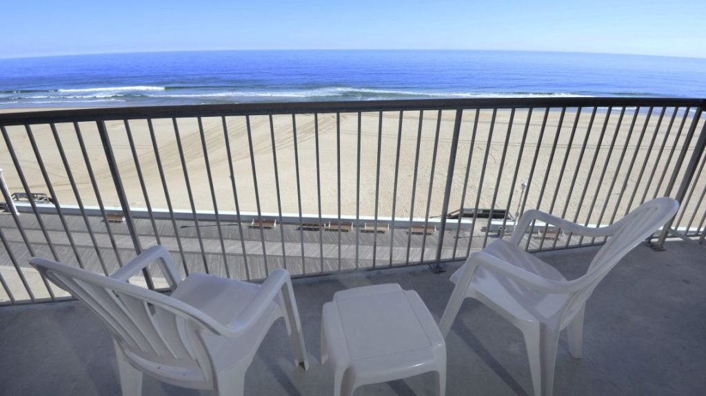oceanview balcony with tables and chairs