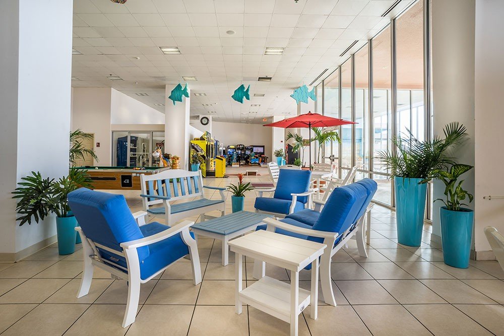 hotel game room with arcade pool table tables and chairs