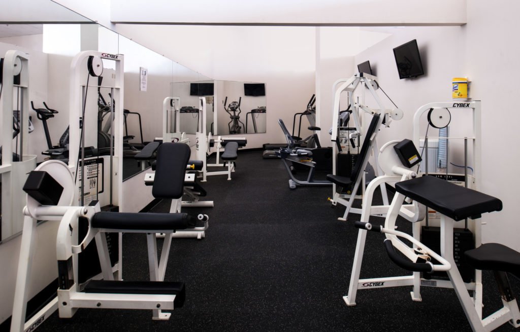 gym with weight machines and tvs