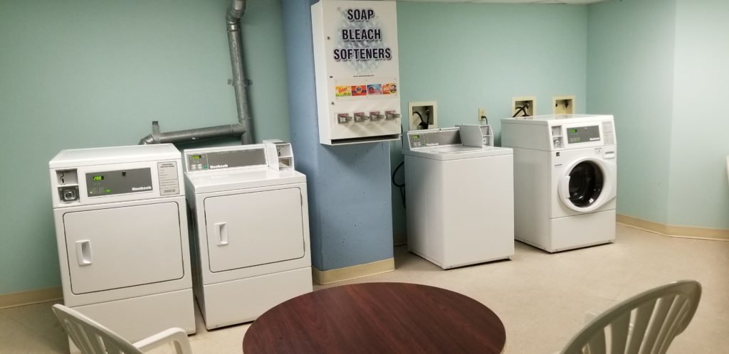 hotel laundry room with washers and dryers