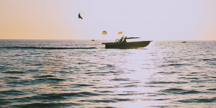 parasailing with boat in ocean