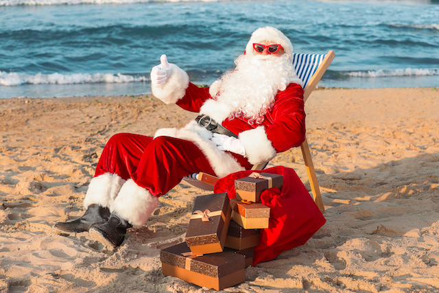Happy Santa Claus with gifts at sea resort