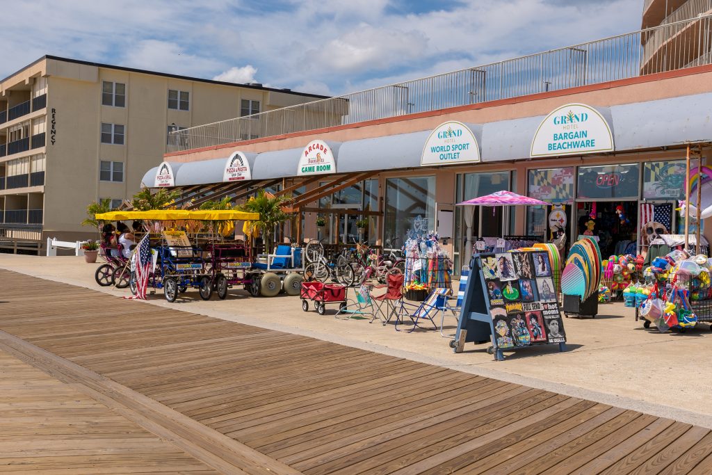 The grand hotel on the boardwalk and shops in front.