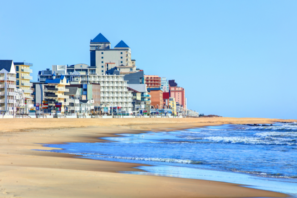 Ocean City, MD beach with boardwalk and condo buildings in the back.