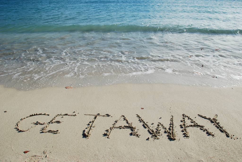 Getaway written in the sand on the beach