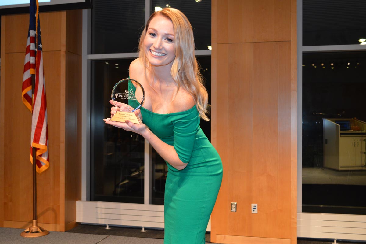 2019 entrepreneur of the year finalist posing with award