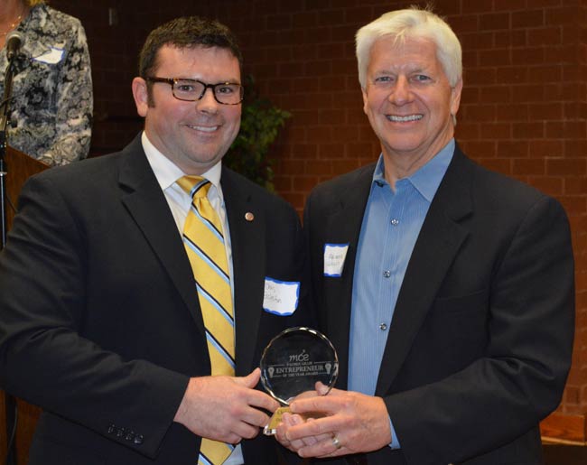 2015 entrepreneur of the year with award posing with official