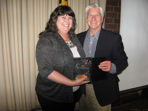 2014 entrepreneur of the year with award posing with official