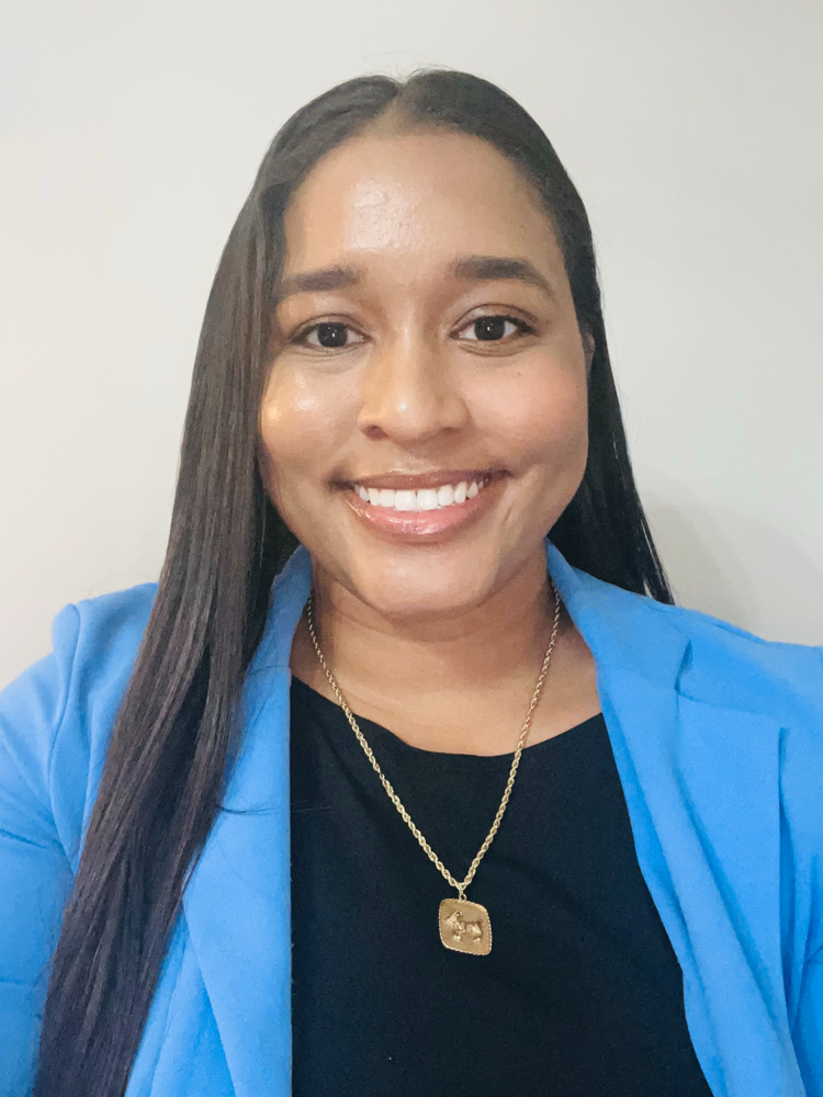 a woman wearing a blue jacket and black shirt