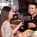 couple holding wine glasses at restaurant