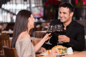 couple holding wine glasses at restaurant