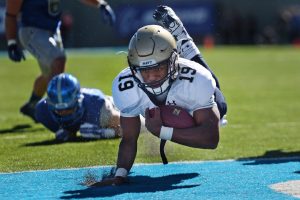 football player diving into the endzone