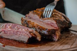 Roast being sliced on a cutting board