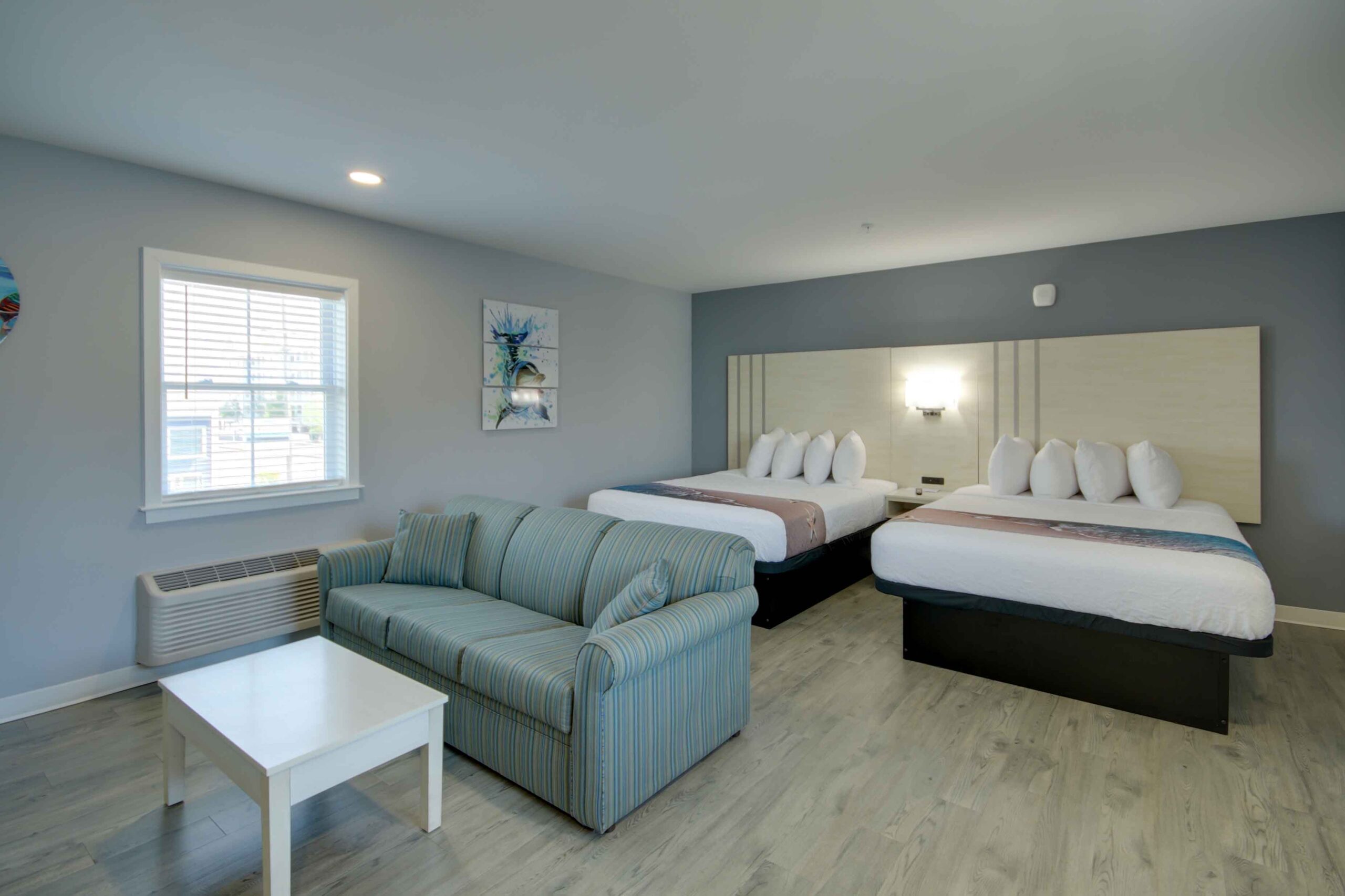 hotel room with two queen beds and sleep sofa
