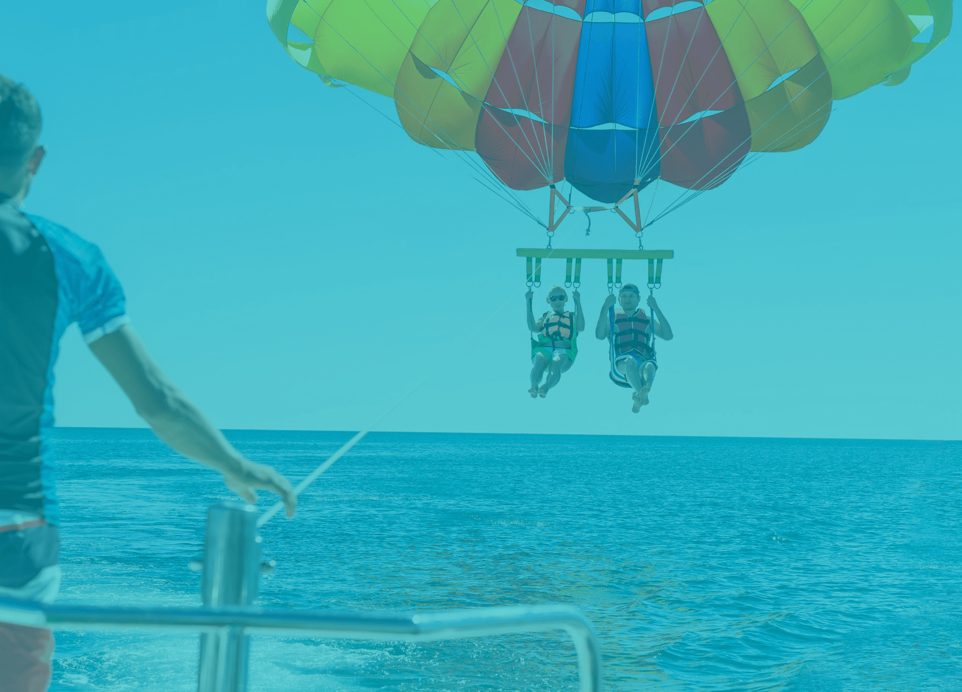 girl and boy parasailing