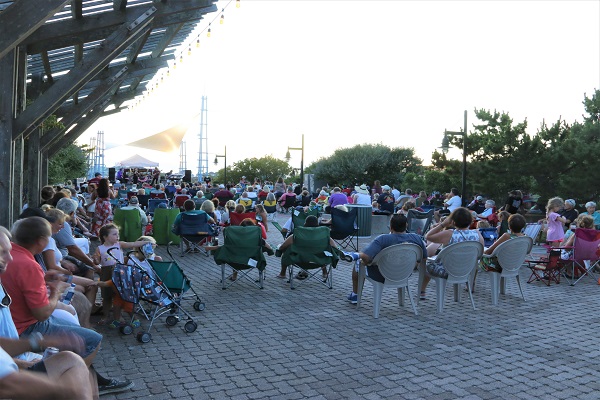 a crowd of people sitting in lawn chairs