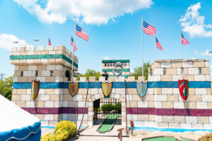 a miniature golf course in front of a castle