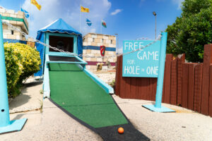 a miniature golf course with a free game for hole one