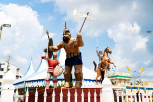 a statue of a man holding a sword next to other statues