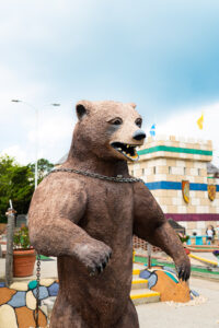 a statue of a bear with chains around its neck
