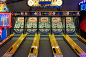 a bowling alley with neon signs and neon lights