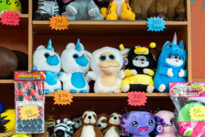 a shelf filled with lots of stuffed animals