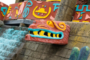 a water slide with a dragon head on top of it