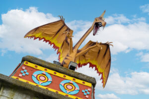 a statue of a dragon on top of a building