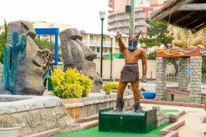 a statue of a man holding a golf club