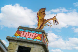 a statue of a dragon on top of a building