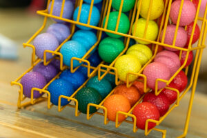 a rack filled with lots of colorful balls