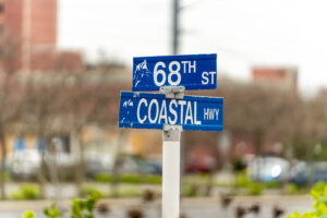a couple of blue street signs sitting on top of a white pole