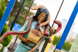 a statue of a person holding a basket